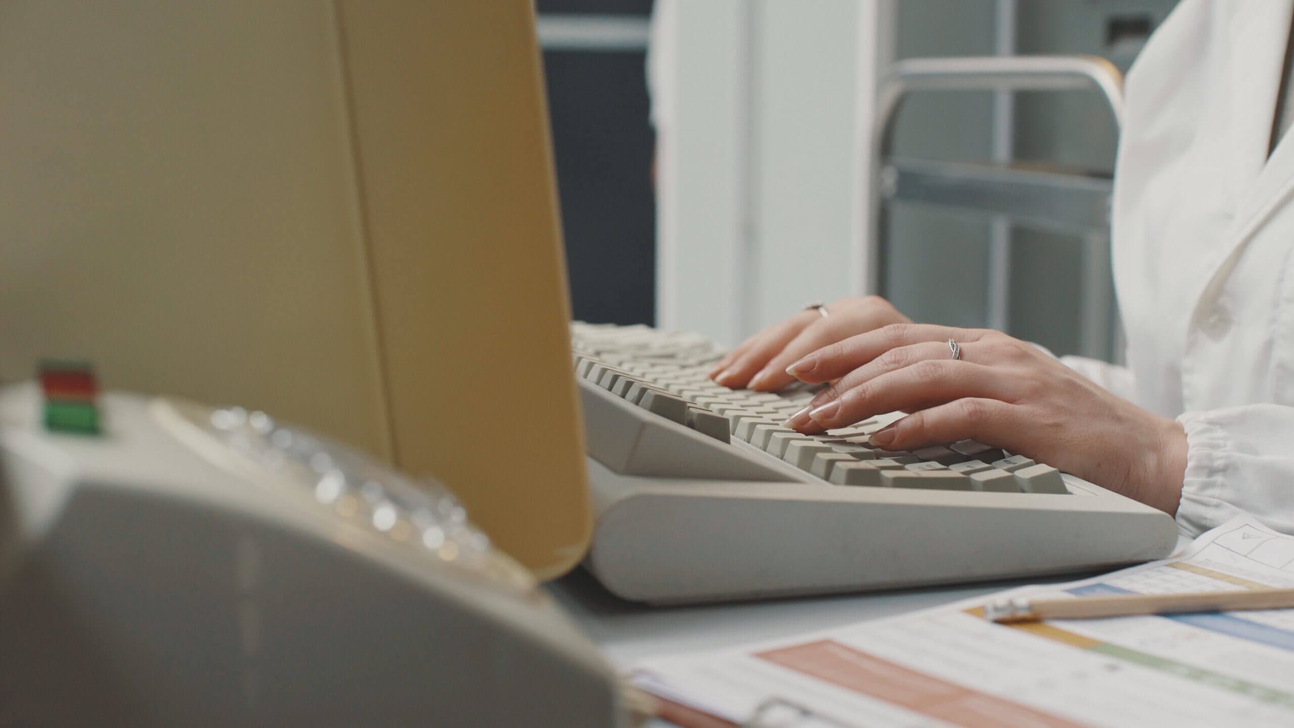 Woman working with an old computer